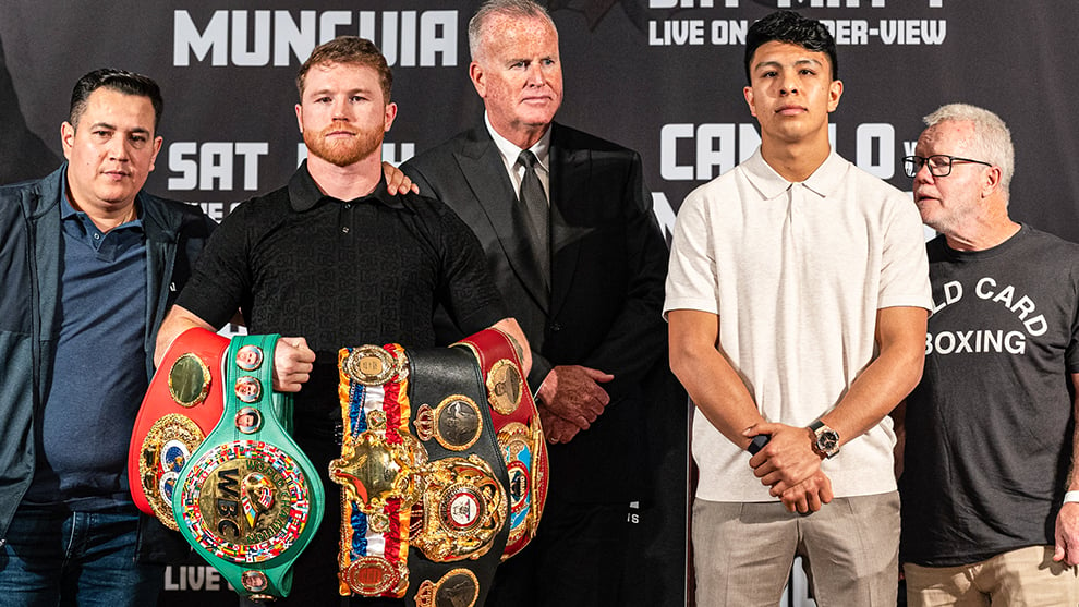 Canelo poses with all the belts next to Munguia
