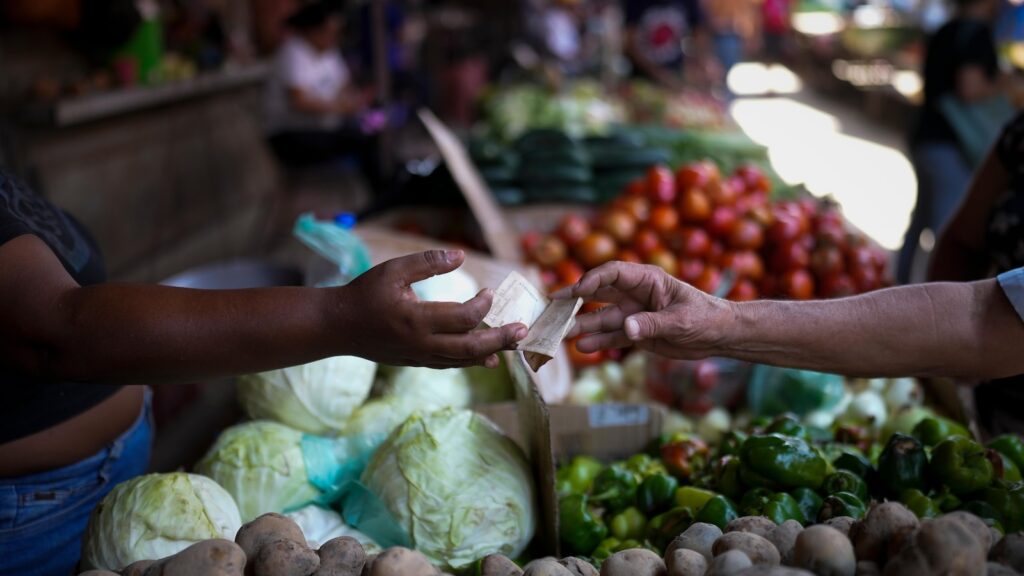 Venezuelans turn to odd jobs and gambling to stretch meager wages they hope will grow after election