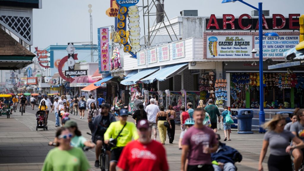 Summer tourists flock to boardwalks and piers while sticking to their budgets