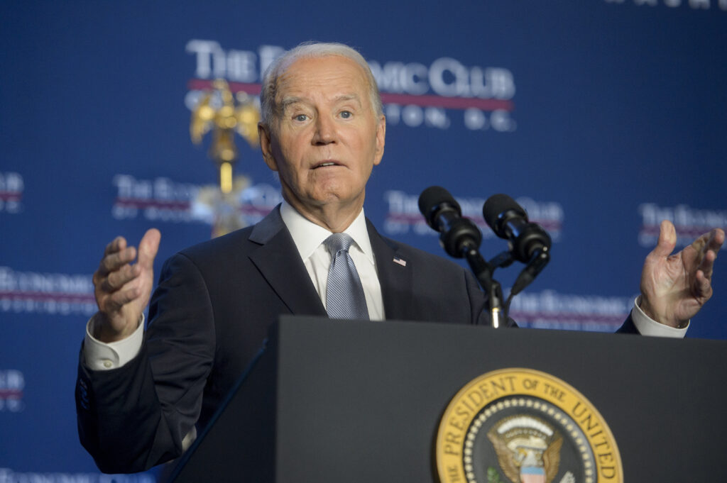 Biden touts economic gains, acknowledges a long way to go