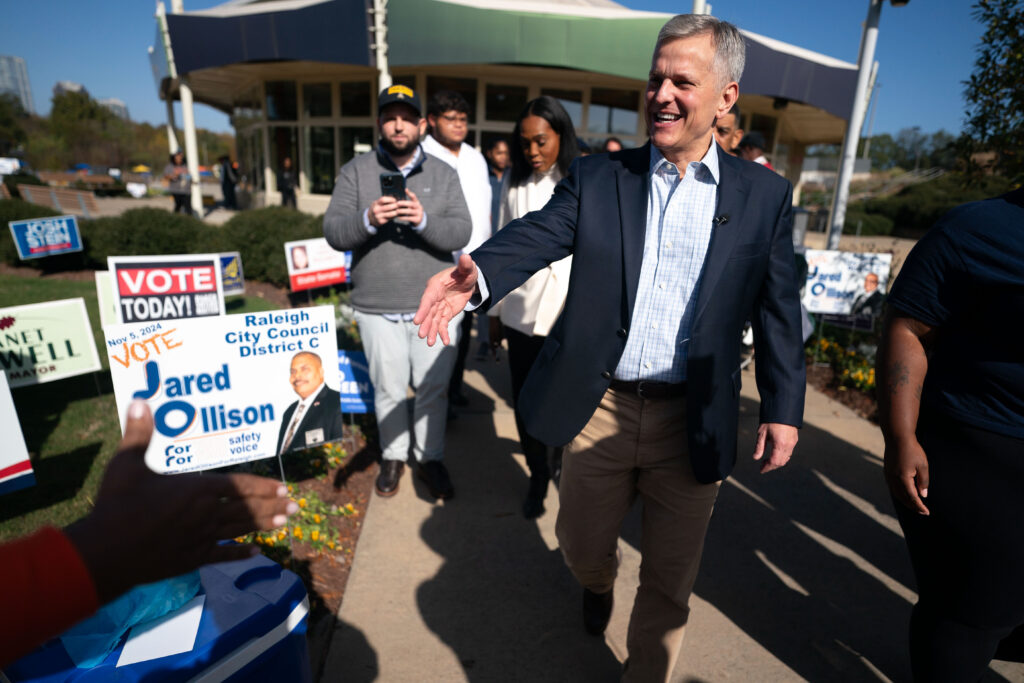 North Carolina Democratic candidate for governor, Josh Stein, reaches out to shake hands outside of a polling location on Election Day at John Chavis Memorial Park in Raleigh, North Carolina, on Nov. 5.