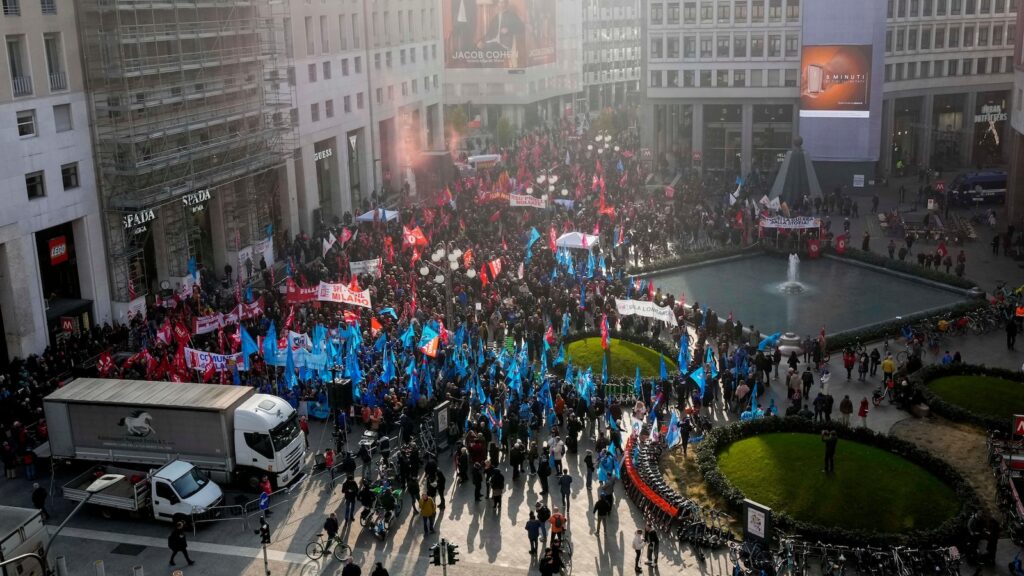 Thousands of workers march across Italy in general strike demanding better pay and services