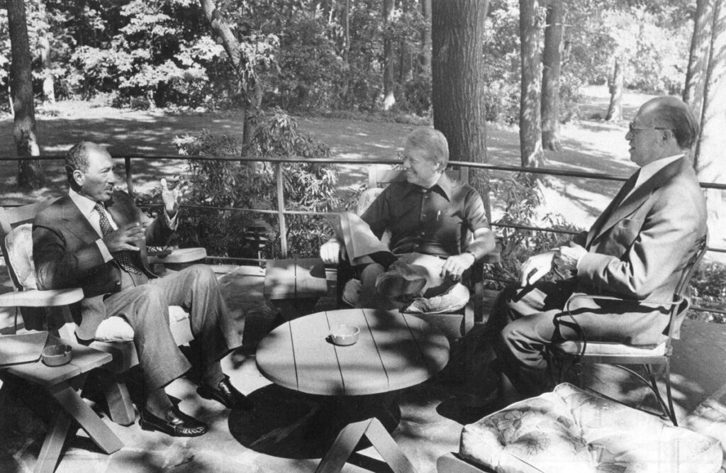 From left, Egyptian President Anwar Sadat, Carter and Israeli Prime Minister Menachem Begin meet at Camp David on Sept. 6, 1978. The three leaders hammered out a historic peace agreement.